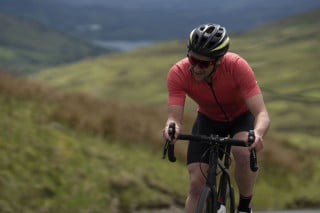 A rider mid-climb on a steep road